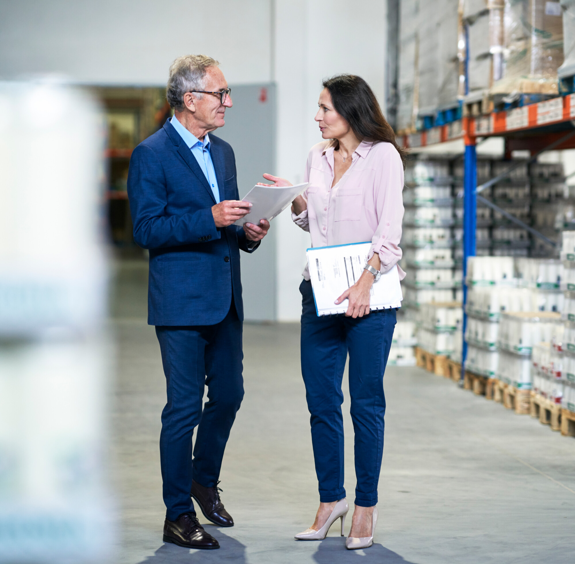 two executives talking in a warehouse