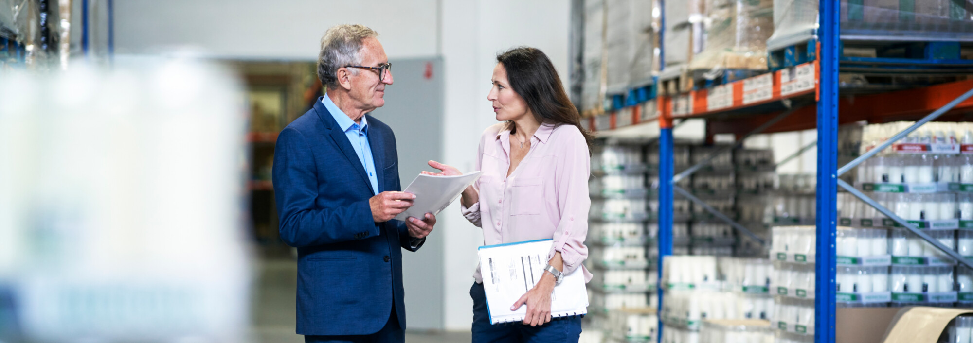 two executives talking in a warehouse